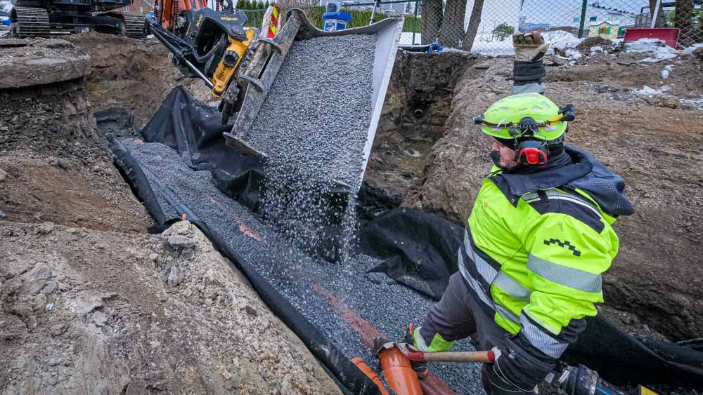 Rørlegger i grøft, singel omfylling rundt rør